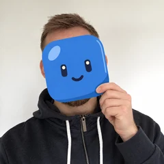 Ben Mann holding a drawn Jellyfolk block in front of his face